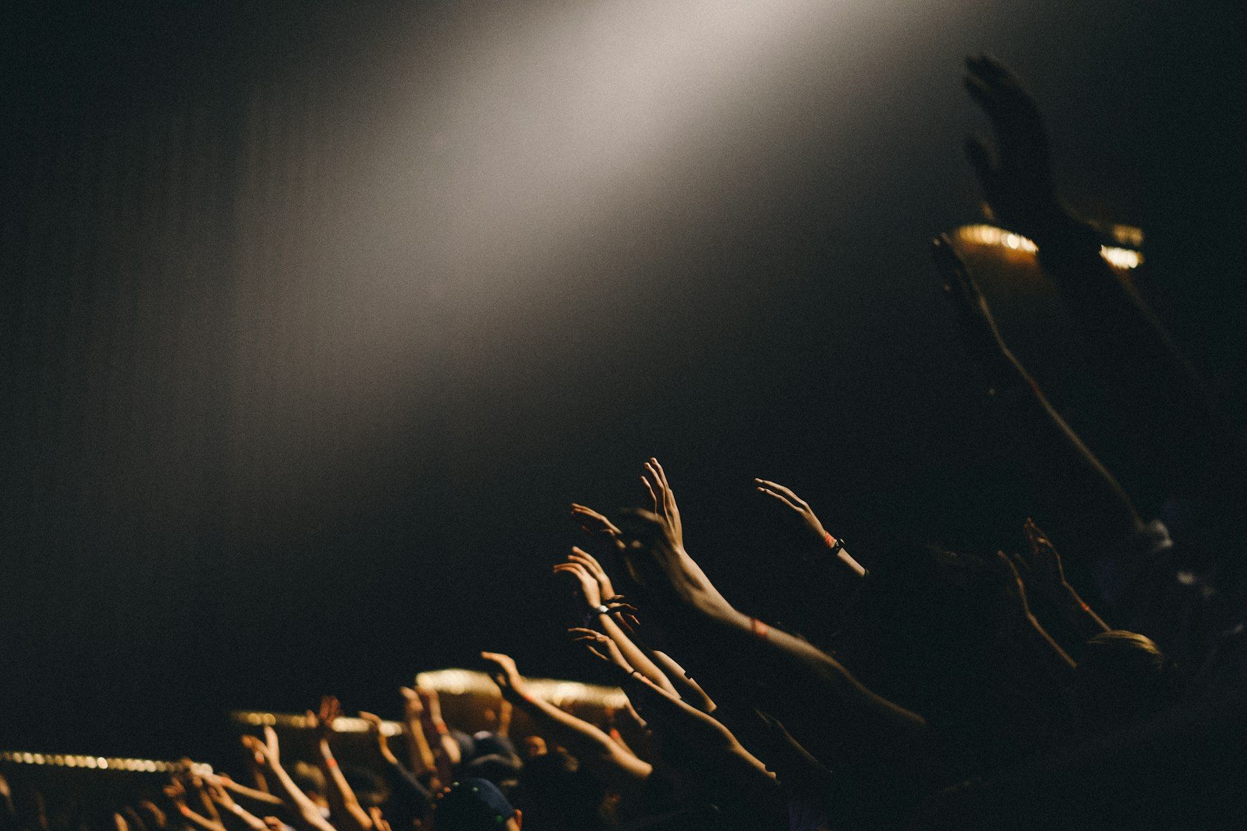 Hands raised in a dark room
